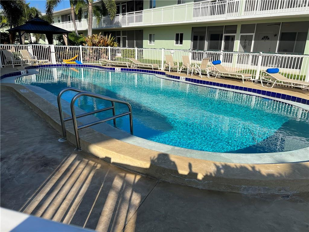 2100 Northeast 38th Street, Unit 124 Lighthouse Point, FL 33064 - Photo 18 of 30 a view of a house with a swimming pool