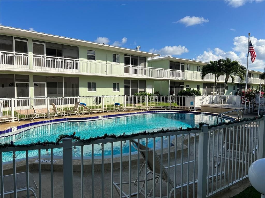 2100 Northeast 38th Street, Unit 124 Lighthouse Point, FL 33064 - Photo 19 of 30 a view of a house with a wooden deck