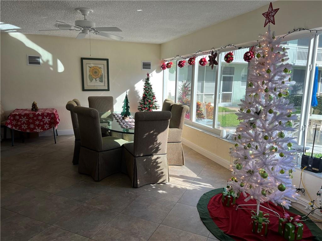 2100 Northeast 38th Street, Unit 124 Lighthouse Point, FL 33064 - Photo 22 of 30 a living room filled with furniture and a chandelier