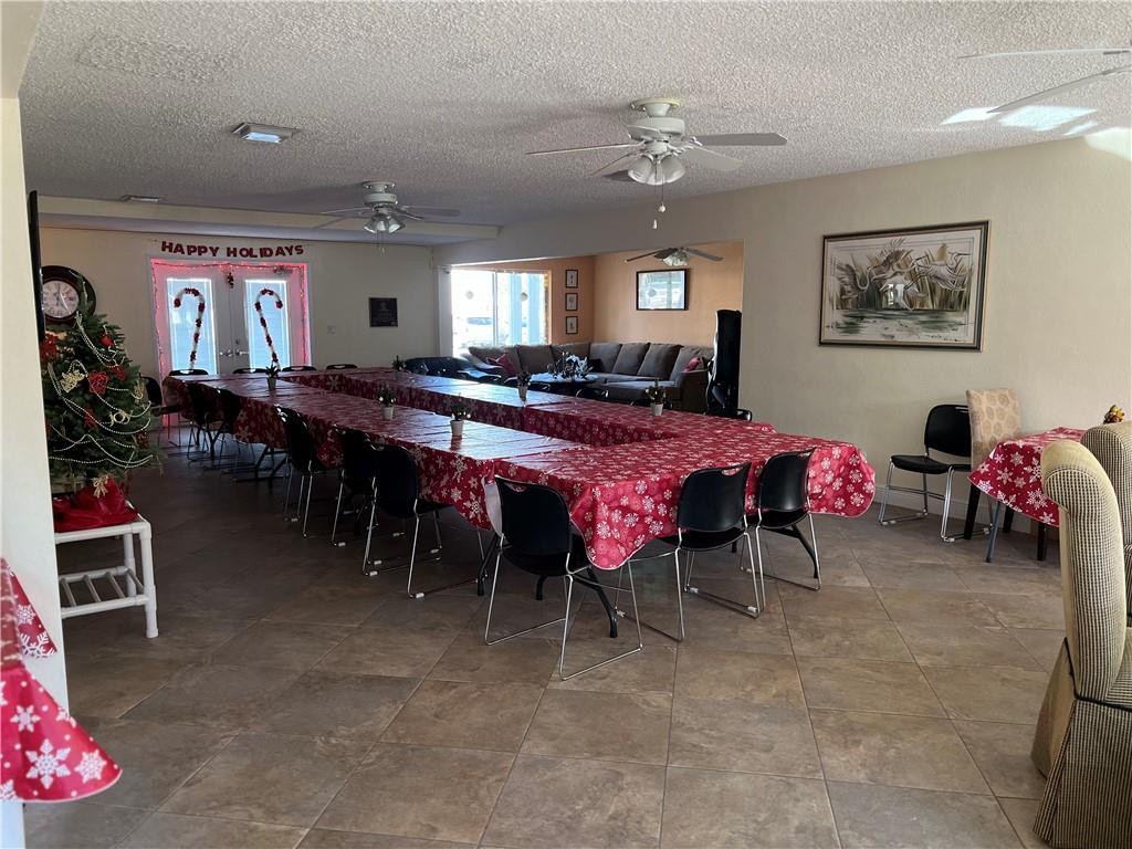 2100 Northeast 38th Street, Unit 124 Lighthouse Point, FL 33064 - Photo 23 of 30 a view of a dining room with furniture and chandelier