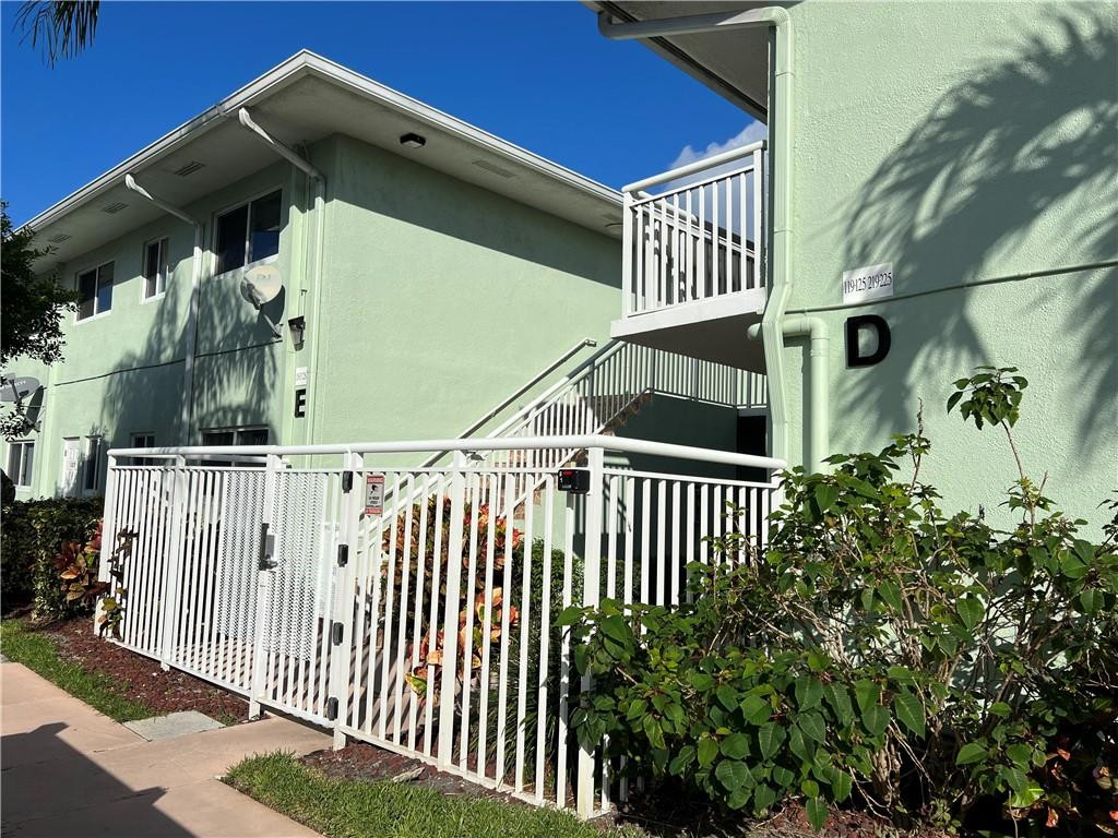 2100 Northeast 38th Street, Unit 124 Lighthouse Point, FL 33064 - Photo 28 of 30 a view of a house with a small yard