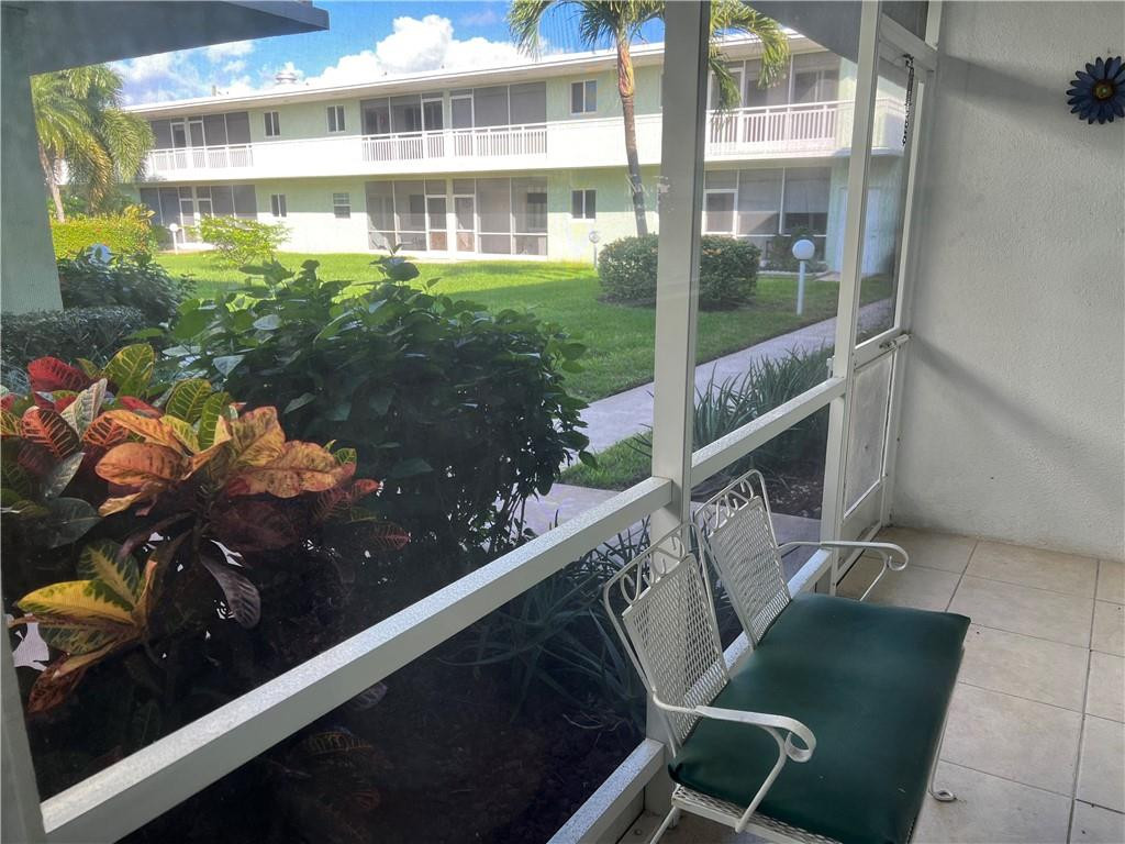 2100 Northeast 38th Street, Unit 124 Lighthouse Point, FL 33064 - Photo 4 of 30 a balcony with chairs and a table