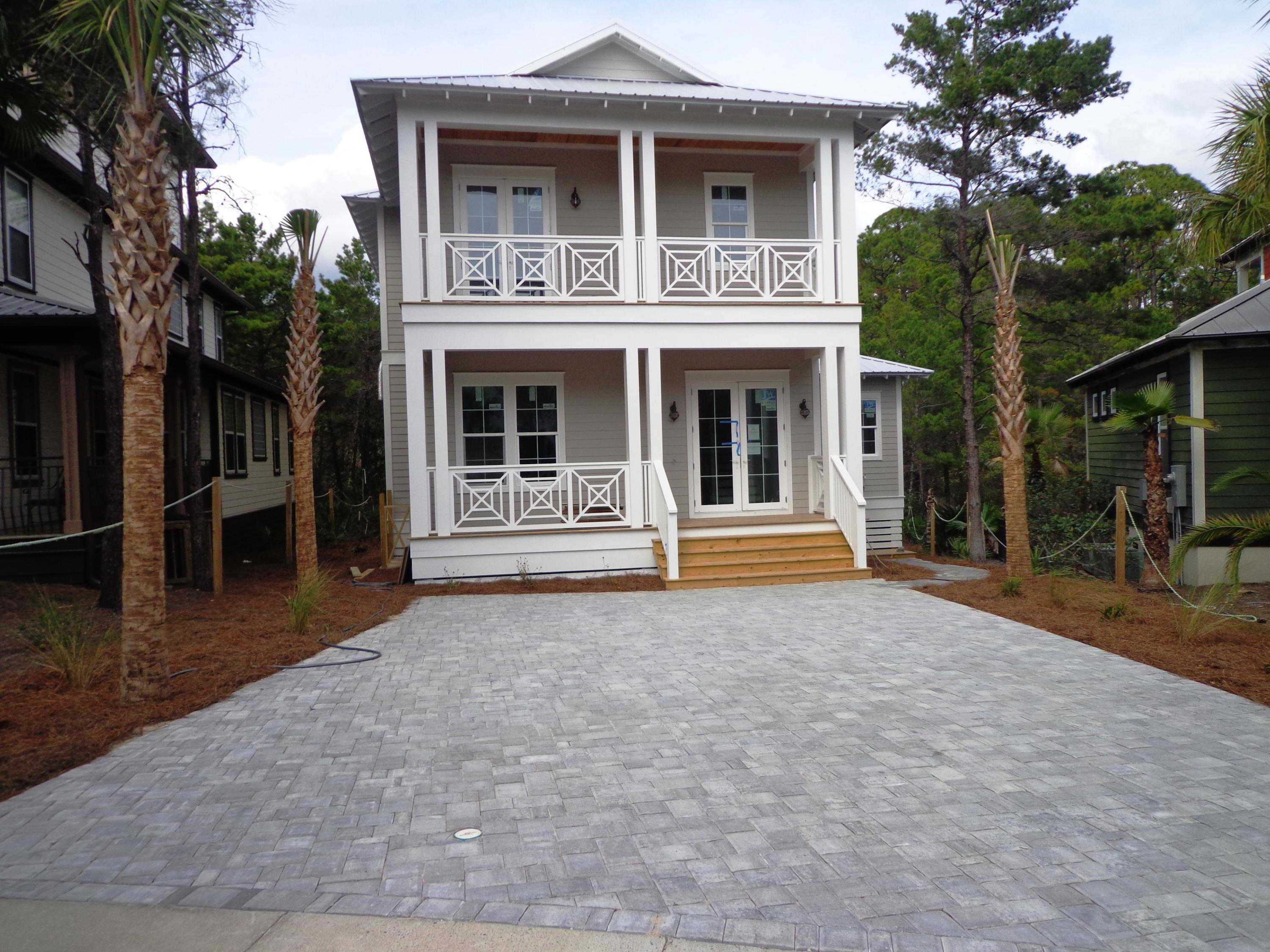 39 Lifeguard Loop Seacrest, FL 32461 - Photo 17 of 59 a front view of a house with a yard and garage