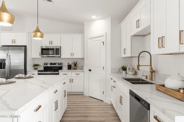 a kitchen with white cabinets and appliances