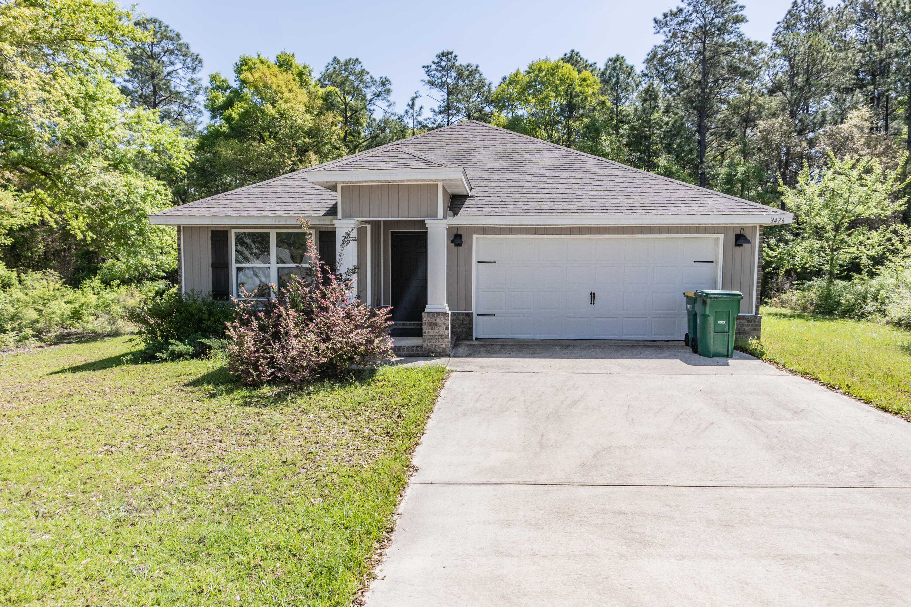 3476 Sparco Drive Crestview, FL 32539 - Photo 2 of 24 a front view of house with yard and trees around