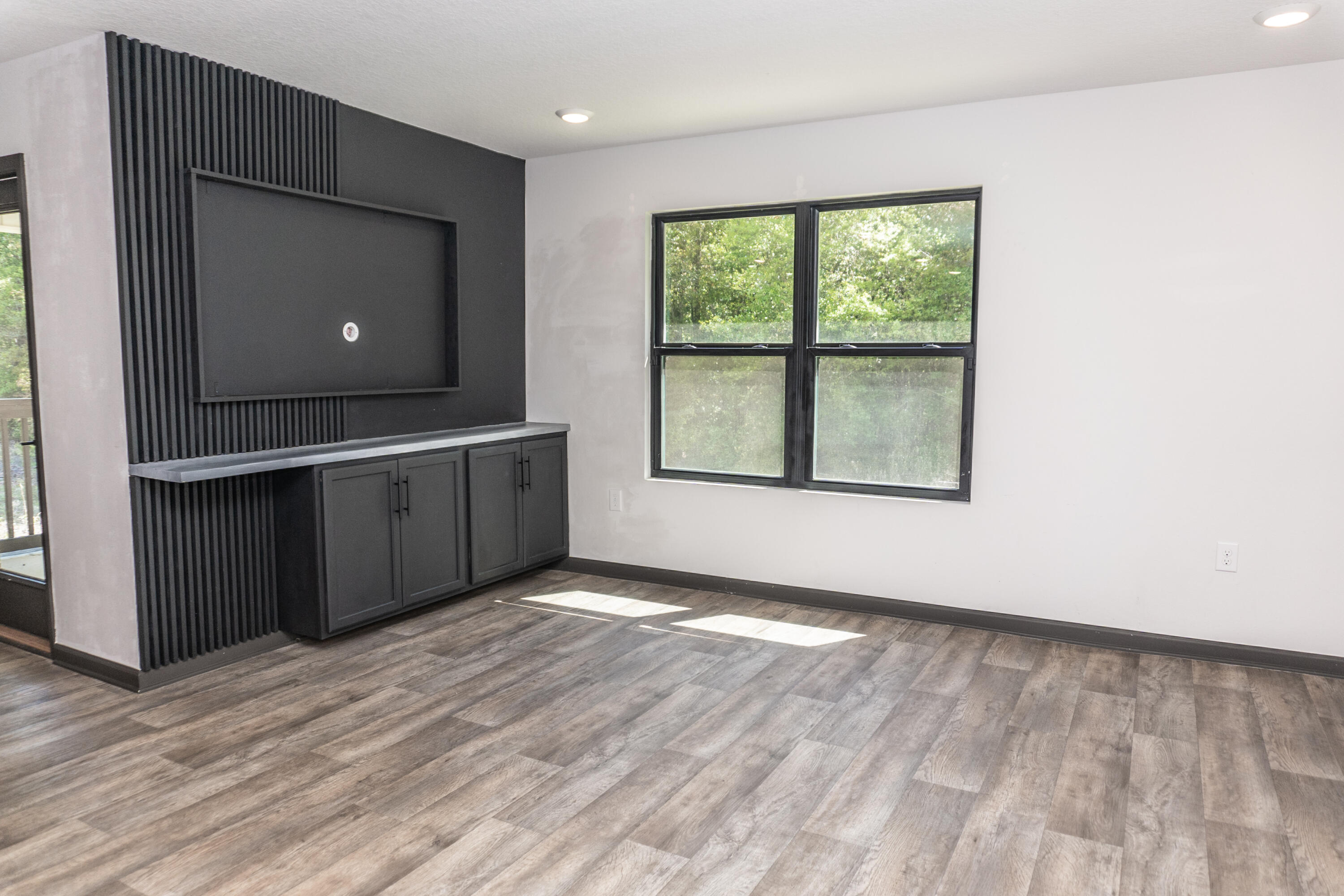 3476 Sparco Drive Crestview, FL 32539 - Photo 10 of 24 a view of an empty room with wooden floor and a window