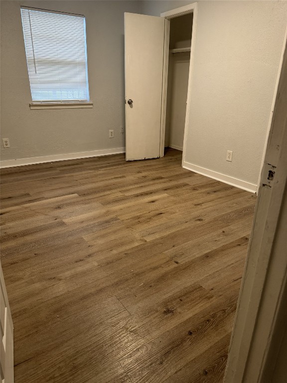9100 Dodson Street, Unit 16 Houston, TX 77093 - Photo 9 of 14 a view of an empty room with wooden floor and a window
