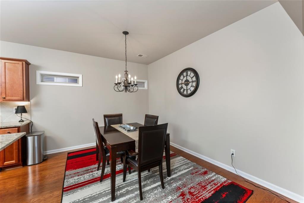 113 Tyson Woods Road Acworth, GA 30102 - Photo 11 of 37 a view of a room with a table chairs and wooden floor
