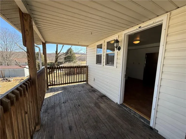 a view of a porch with wooden floor