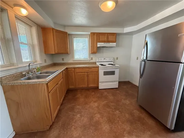 a kitchen with a sink stove and refrigerator