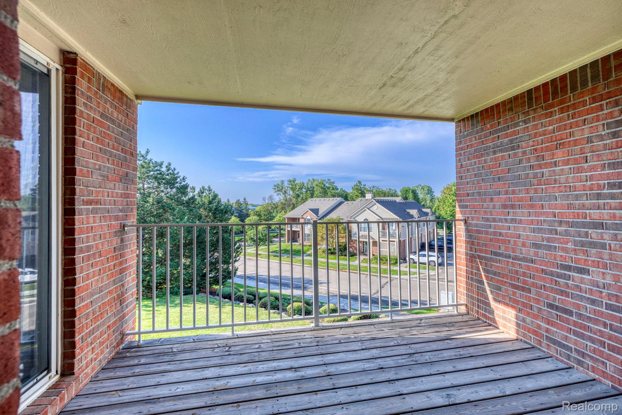 1905 Flagstone Circle Rochester, MI 48307 - Photo 29 of 33 Balcony with wood-finish flooring, brick exterior walls, and a metal railing