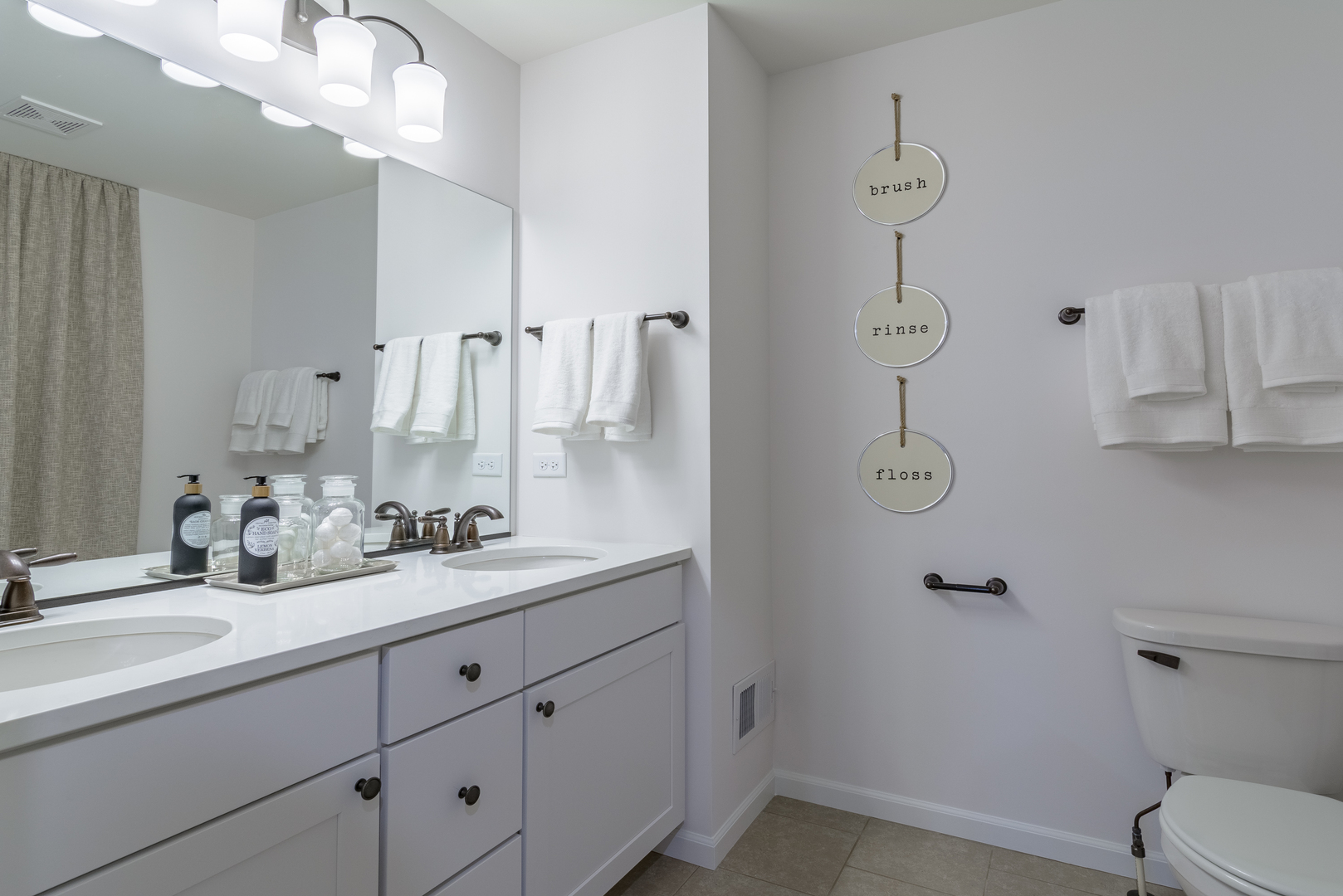 591 North Highlander Way Addison, IL 60101 - Photo 18 of 25 a bathroom with a toilet sink and mirror
