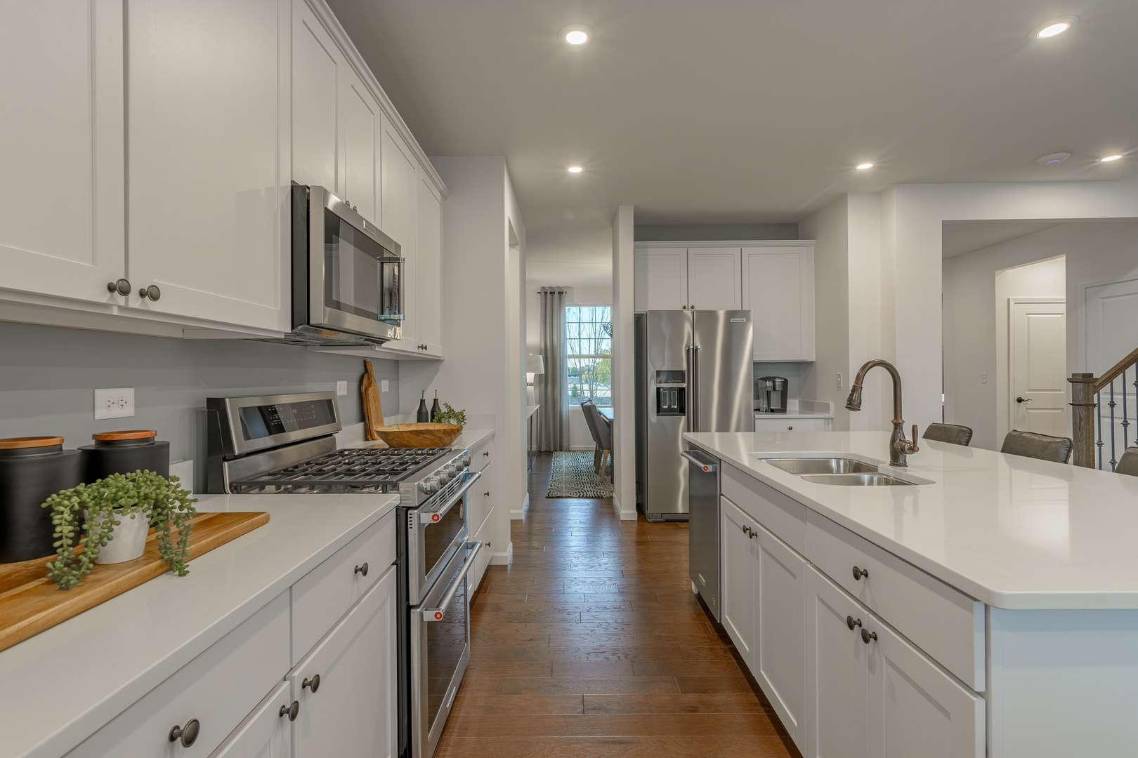 591 North Highlander Way Addison, IL 60101 - Photo 7 of 25 a kitchen with stainless steel appliances granite countertop a sink stove refrigerator and cabinets