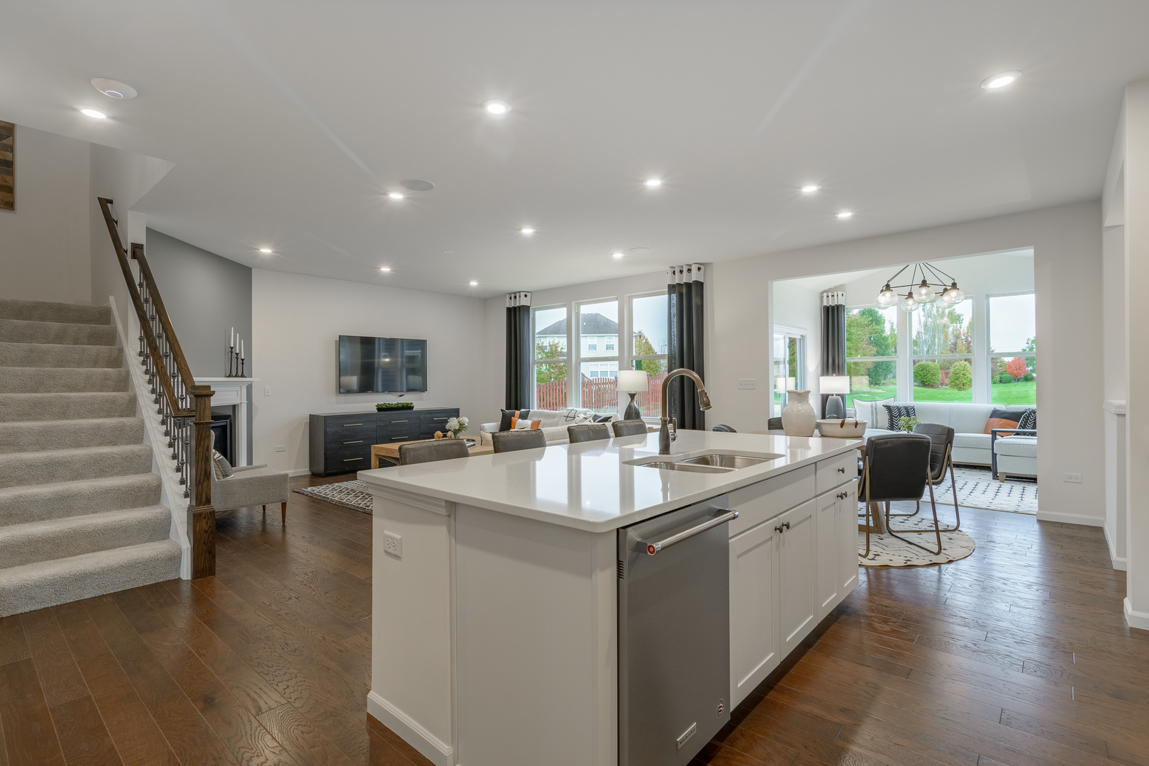 591 North Highlander Way Addison, IL 60101 - Photo 8 of 25 a large white kitchen with sink stove and wooden floor
