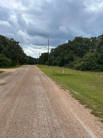 a view of a field with an ocean view