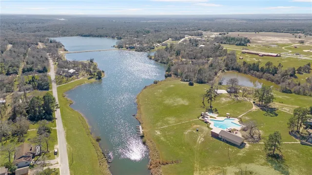 an aerial view of a residential houses with outdoor space and ocean view