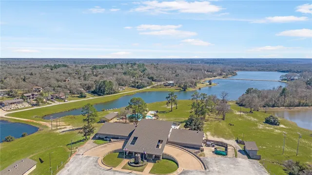 an aerial view of a house with a lake view