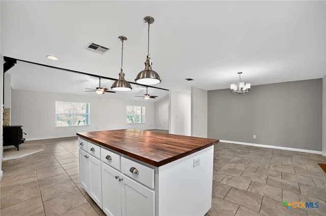 a kitchen with kitchen island a sink a counter space and appliances