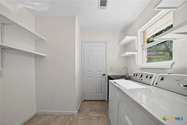 a utility room with dryer and washer