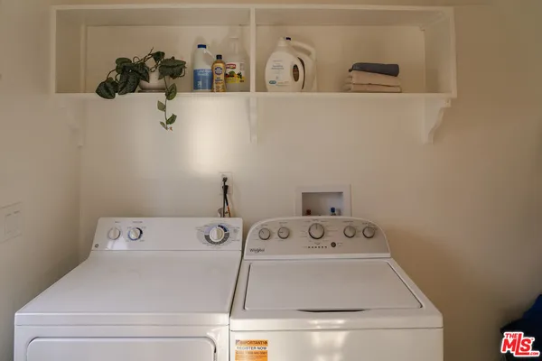 a view of a storage and utility room with a window