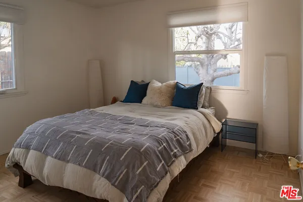 a bedroom with a bed and window