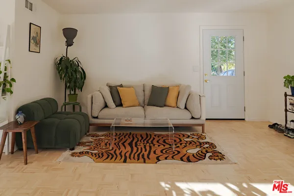 a living room with furniture lamp and window