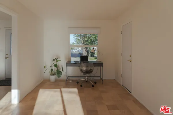a dining room with furniture and a floor to ceiling window