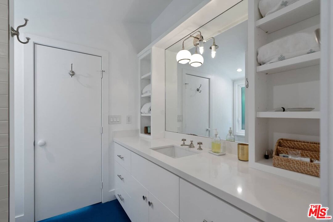 249 Paradise Cove Road Malibu, CA 90265 - Photo 19 of 41 a en suite bathroom with a double vanity sink and a mirror