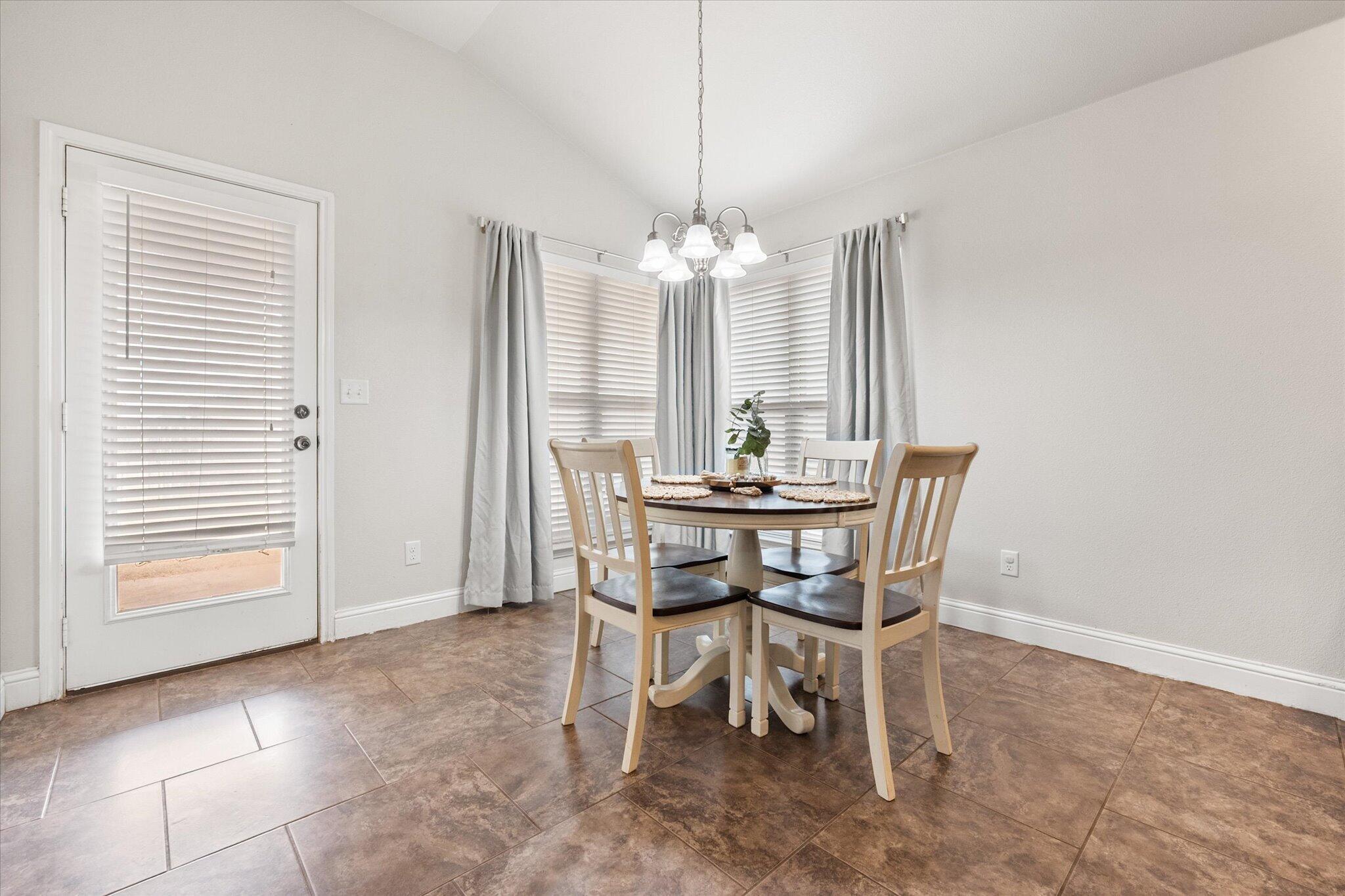 7026 97th Street Lubbock, TX 79424 - Photo 11 of 30 a dining room with furniture and window