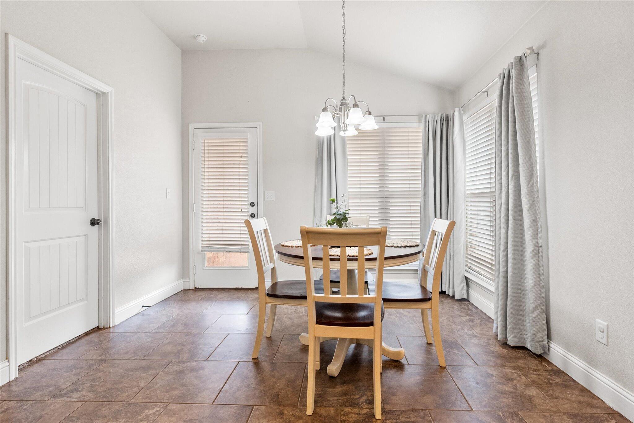 7026 97th Street Lubbock, TX 79424 - Photo 12 of 30 a view of a dining room with furniture and window