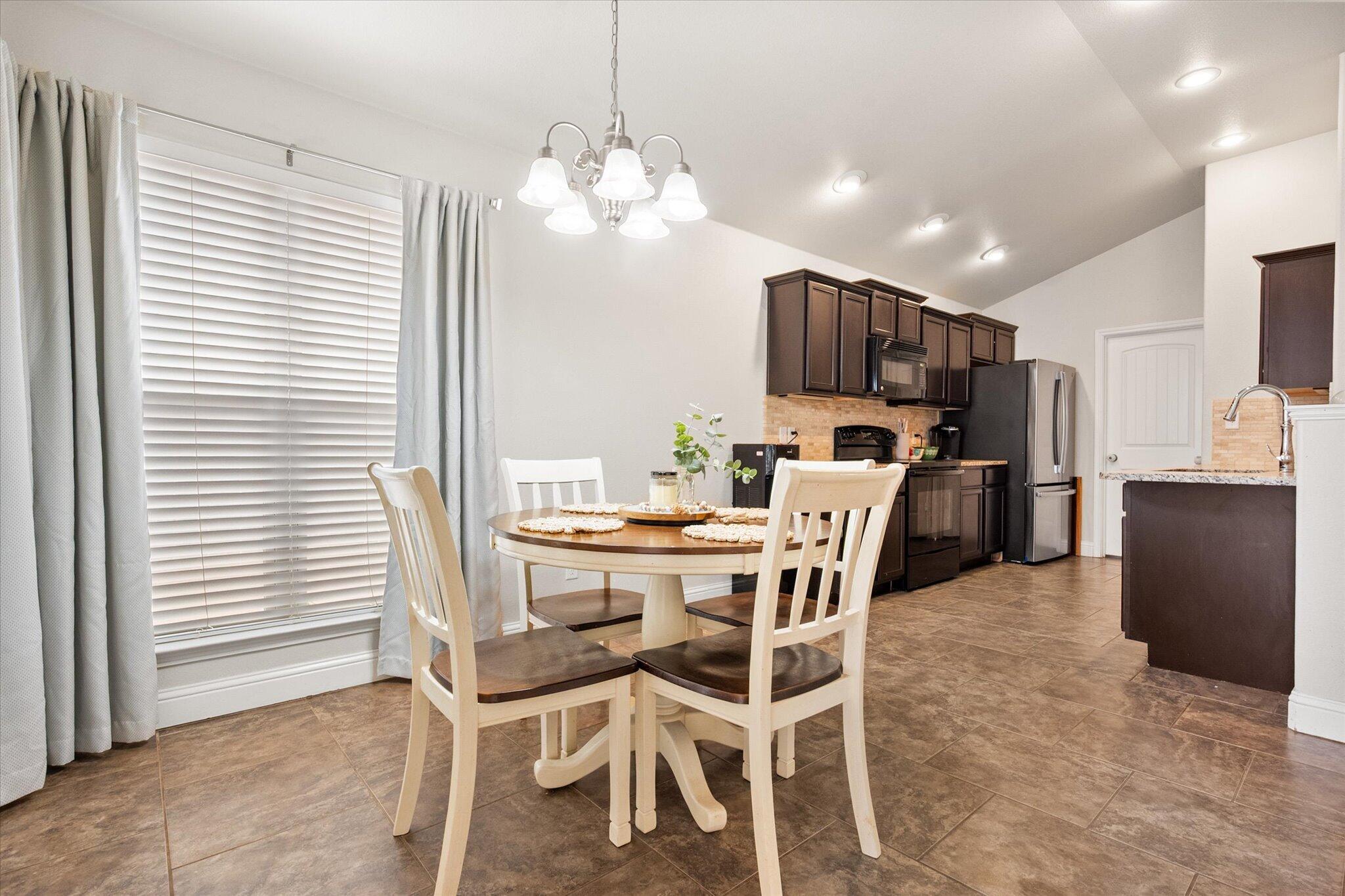 7026 97th Street Lubbock, TX 79424 - Photo 10 of 30 a view of a dining room with furniture and chandelier