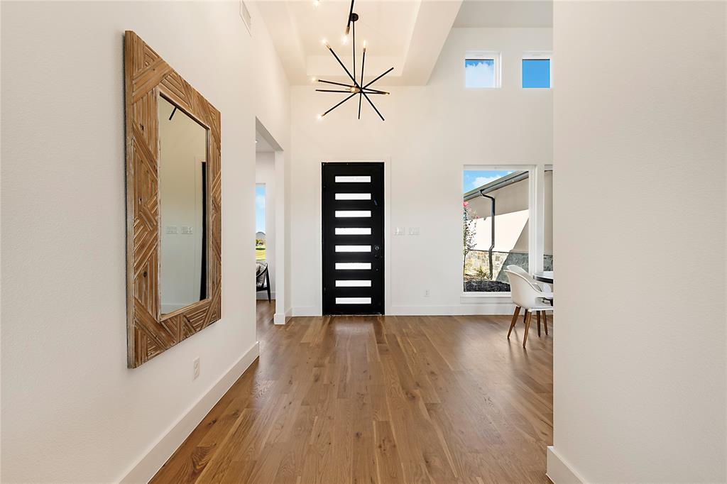 430 Whispering Way Red Oak, TX 75154 - Photo 11 of 40 Foyer featuring soaring ceilings, a contemporary chandelier, and wood-finish flooring