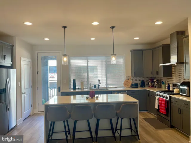 a kitchen with counter space and chairs