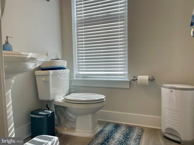 a dining room with furniture and a wooden floor