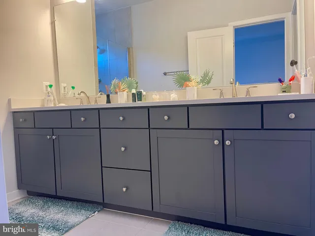 a bathroom with a double vanity sink and a mirror