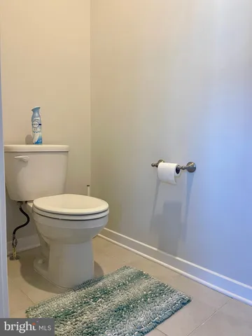 a view of a hallway with wooden floor and furniture