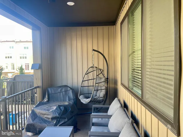 a front view of a house with outdoor seating