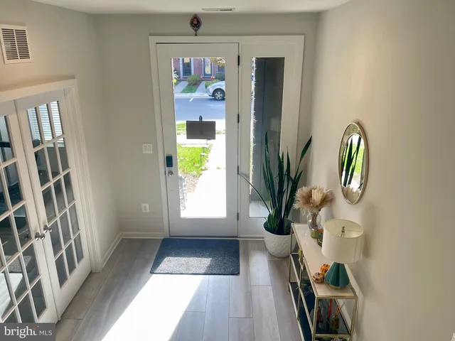 a view of a workspace with wooden floor and a window
