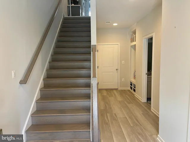 a view of an entryway with wooden floor