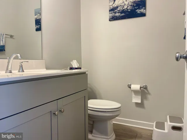 a bathroom with a sink mirror vanity and toilet