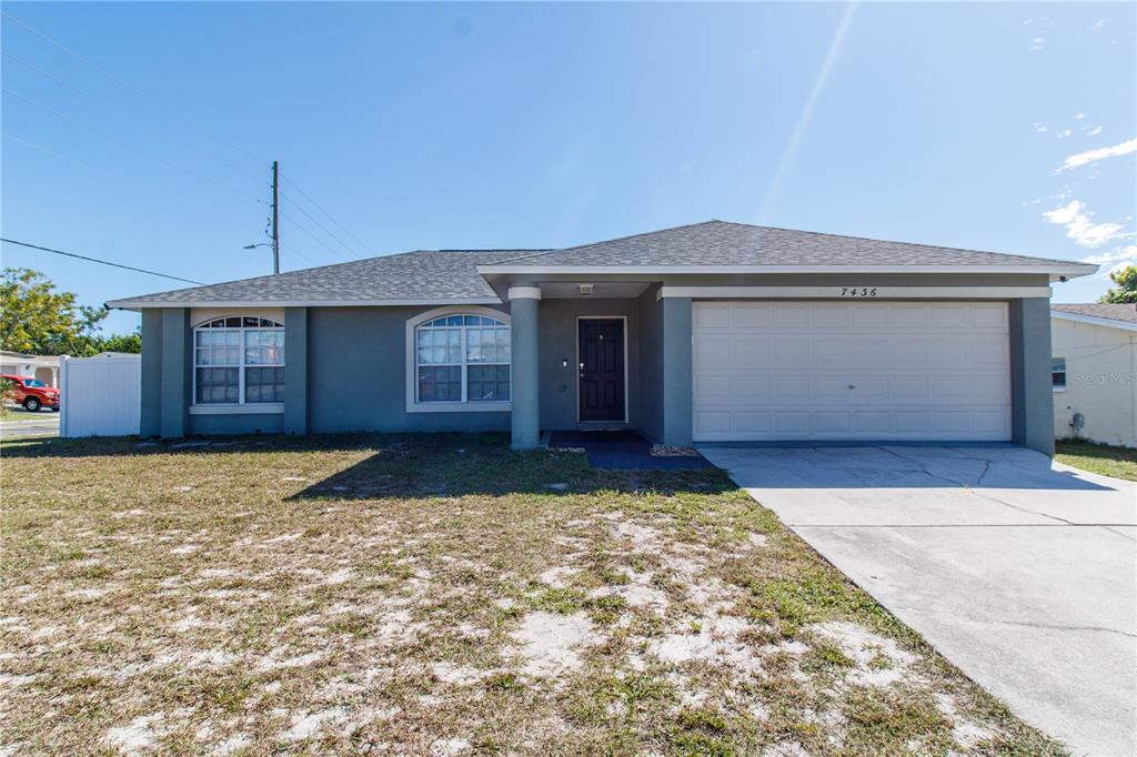 7436 Gulf Highlands Drive Port Richey, FL 34668 - Photo 1 of 1 a front view of a house with a yard and garage