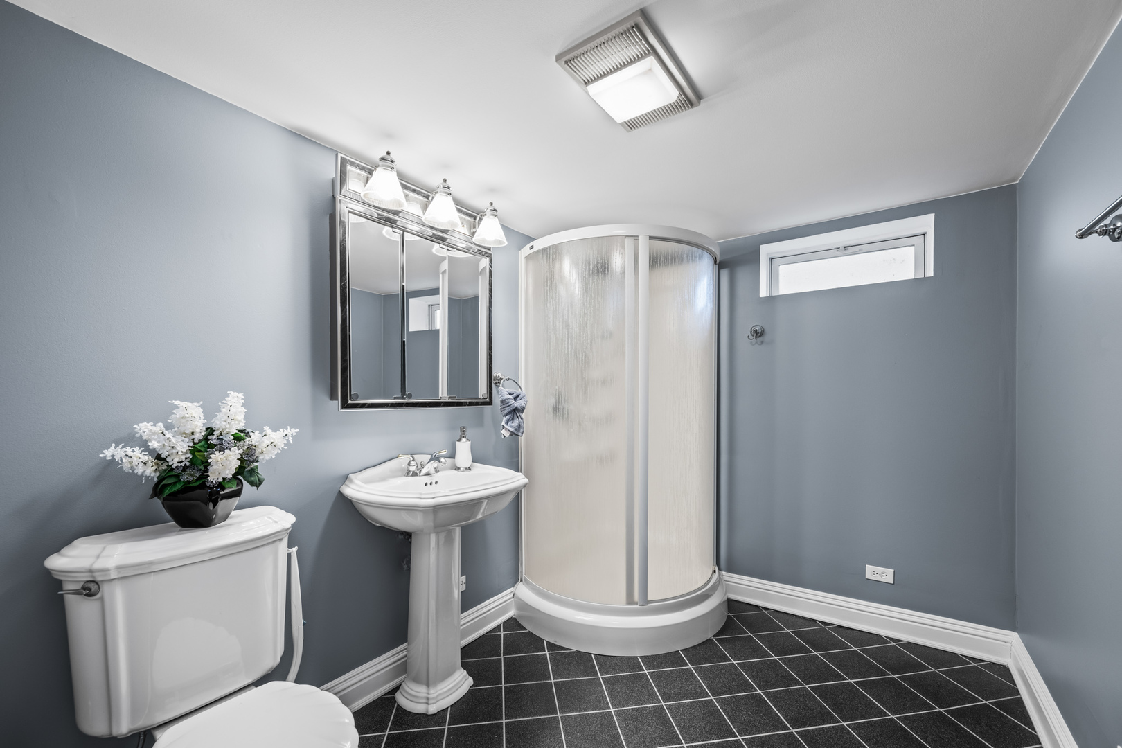 906 South Tower Lane Mount Prospect, IL 60056 - Photo 17 of 24 a bathroom with a toilet sink and mirror