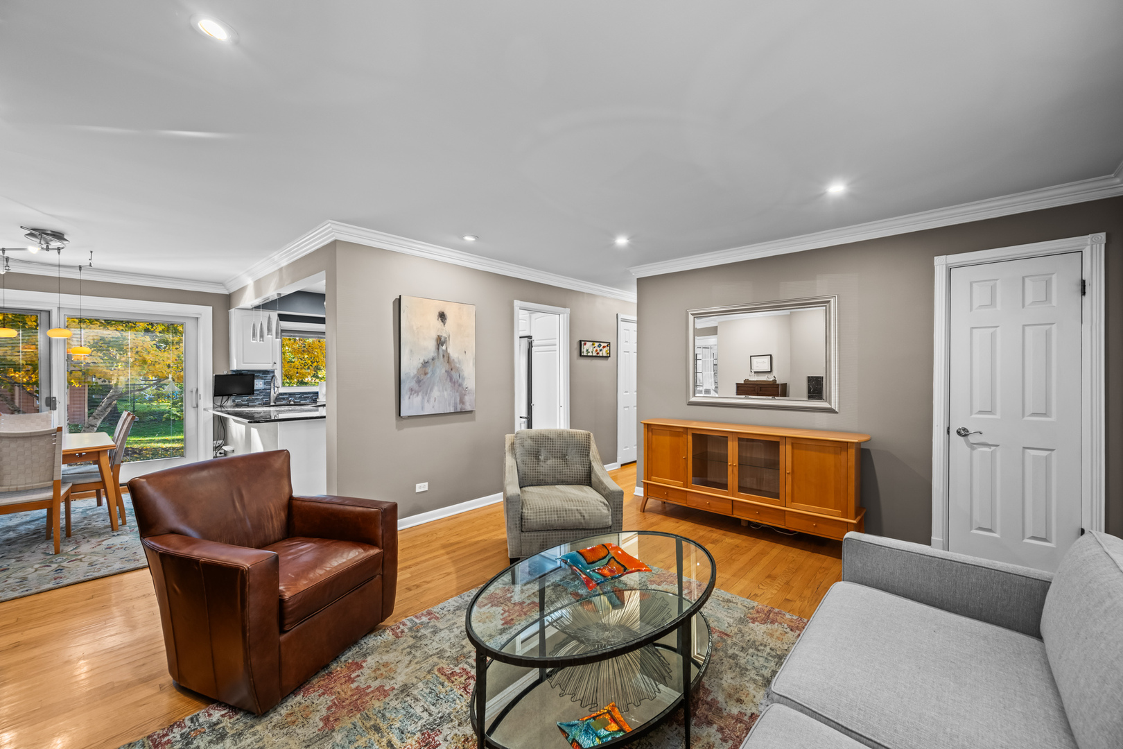 906 South Tower Lane Mount Prospect, IL 60056 - Photo 5 of 24 a living room with furniture a rug kitchen view and a window