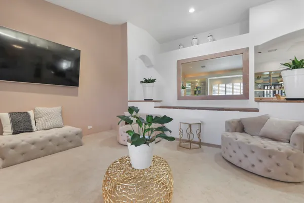 a living room with furniture a flat screen tv and a fireplace