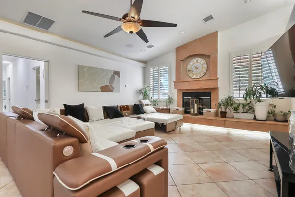 a dining room filled chandelier and kitchen view