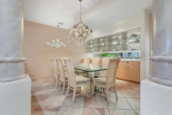 a kitchen with granite countertop white cabinets and white stainless steel appliances