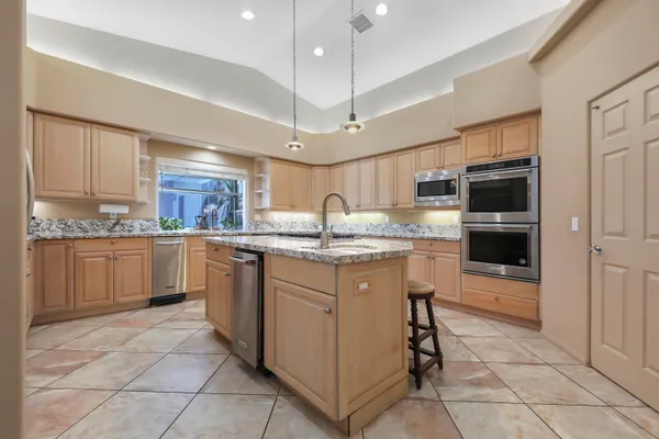 a kitchen with stainless steel appliances granite countertop a sink and cabinets