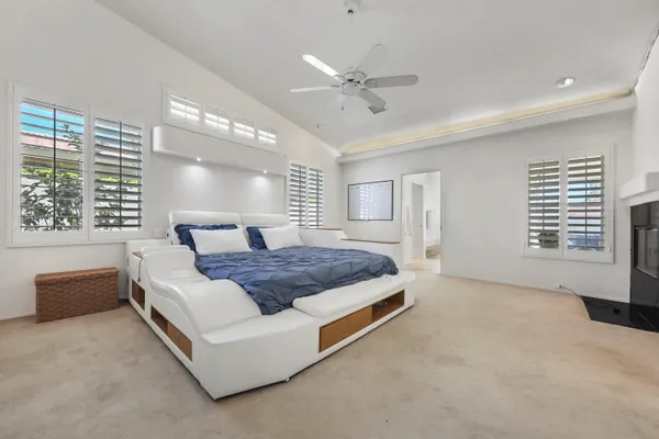 a bedroom with a large bed and a flat screen tv