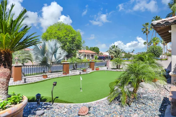 a backyard of a house with a yard and outdoor seating