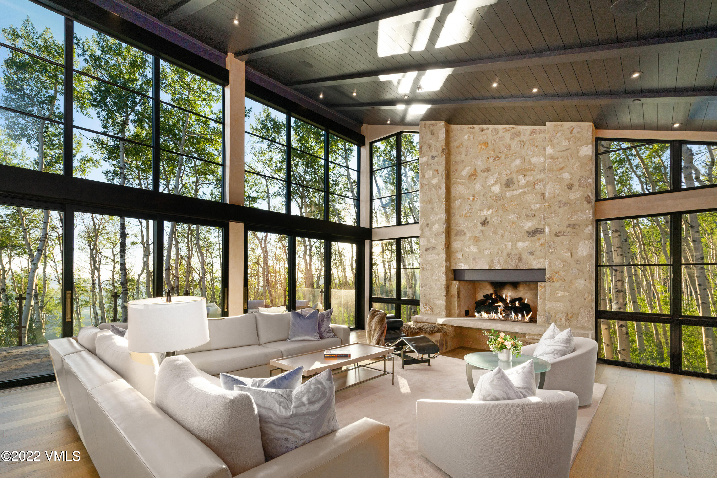 a living room with furniture and a floor to ceiling window